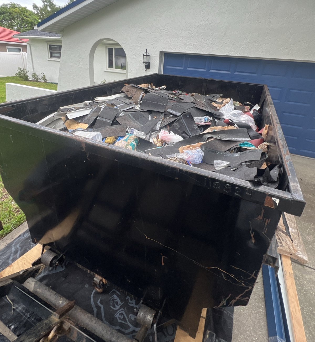 Dumpster lleno de escombros de un proyecto de techado